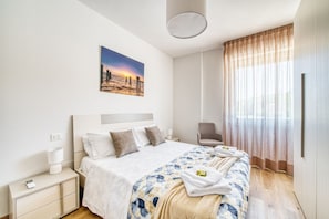 A modern hotel room with a bed, bedside table, chair, and a painting on the wall. - A cozy apartment of approximately 60 sqm, perfect for a stay for two, located on the third floor of a building with an elevator.The property is situated in Magione, Umbria, just minutes from Lake Trasimeno in a well-serviced area offering all key ameniti (Magione)