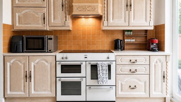 A kitchen with two ovens, a microwave, and a coffee maker on the countertop. - Signature Room I (Egham station – 5 minutes walk) (Egham)