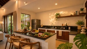 A modern kitchen with a central island, wooden chairs, a refrigerator, and a sink. - Pavilion Pool Villa. Walk to Beach (Kecamatan Mengwi,)