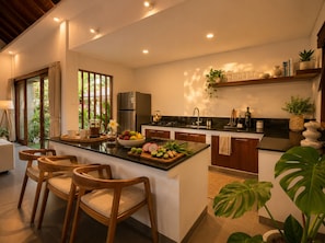 A modern kitchen with a central island, wooden chairs, a refrigerator, and a sink. - Pavilion Pool Villa. Walk to Beach (Kecamatan Mengwi,)