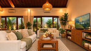 A spacious living room with a sofa set, a coffee table, and a television. - Pavilion Pool Villa. Walk to Beach (Kecamatan Mengwi,)