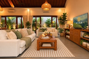 A spacious living room with a sofa set, a coffee table, and a television. - Pavilion Pool Villa. Walk to Beach (Kecamatan Mengwi,)
