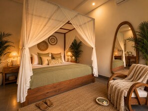 A bedroom with a four-poster canopy bed, bedside tables with lamps, a large mirror, and a woven rug. - Pavilion Pool Villa. Walk to Beach (Kecamatan Mengwi,)