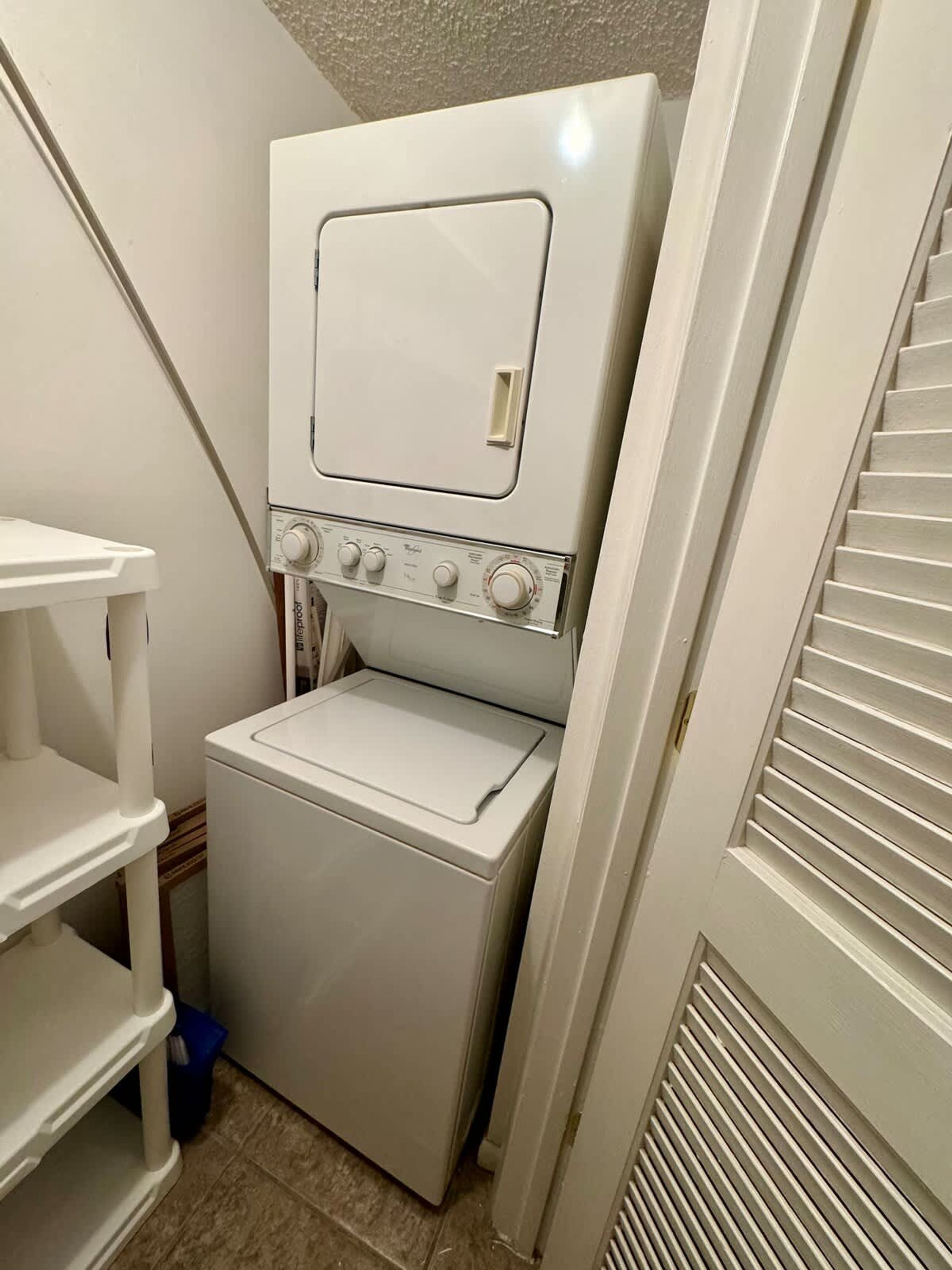 A compact laundry room with a washing machine and dryer.