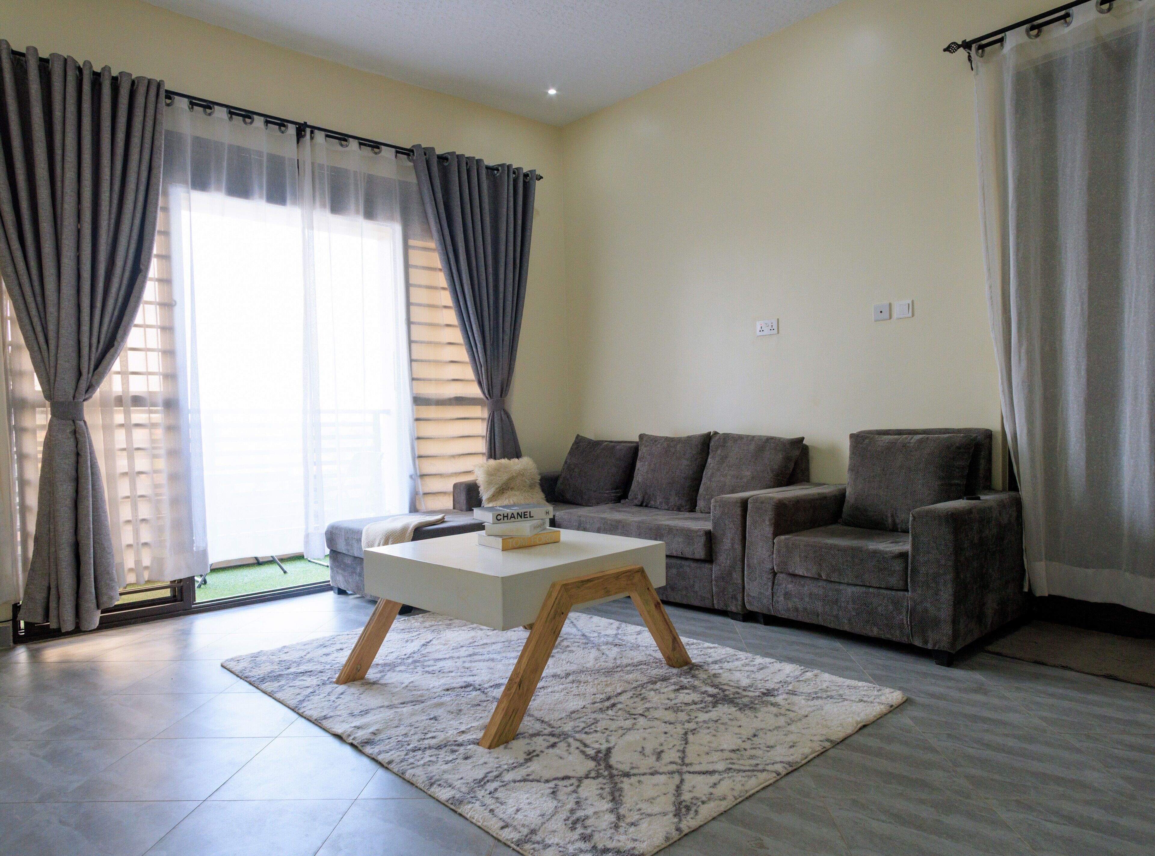 A living room with a sofa set, a coffee table, and a rug.