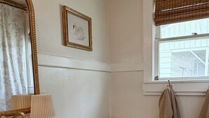 Une salle de bain avec un lavabo en marbre, des toilettes et une fenêtre donnant sur l’extérieur.