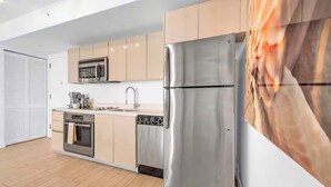 A modern kitchen with stainless steel appliances, a microwave, and a dishwasher. - Waterfront Condo 2BR  Intracoastal Marina (Hallandale Beach)