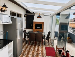 Eine moderne Küche mit integriertem Mikrowellenherd, einem Edelstahl-Kühlschrank und einem schwarzen Backofen.