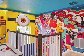 A brightly colored room with a playful mural, a round object on the wall, and a white railing. - 6BR house sleeps 16 in kissimmee, fl (Kissimmee)
