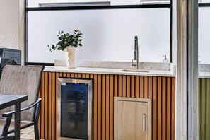 A kitchen area with a built-in dishwasher, a sink, and a potted plant. - 6BR house sleeps 16 in kissimmee, fl (Kissimmee)