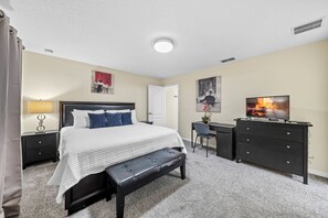 A bedroom with a bed, a desk, a chair, a dresser, and a television. - 4BR house sleeps 10 in kissimmee, florida (Kissimmee)