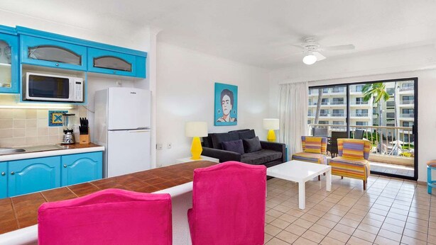 A compact living space with a kitchen, dining area, and a balcony with a view of buildings. - Awesome oceanfront resort with amazing Arch views in fabulous Cabo San Lucas (Cabo San Lucas)