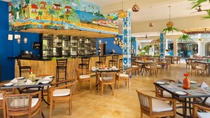 A restaurant with a mural of a tropical scene, wooden furniture, and a bar area. - Awesome oceanfront resort with amazing Arch views in fabulous Cabo San Lucas (Cabo San Lucas)