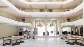 A spacious lobby with multiple seating areas, a reception desk, and a chandelier. - Awesome oceanfront resort with amazing Arch views in fabulous Cabo San Lucas (Cabo San Lucas)