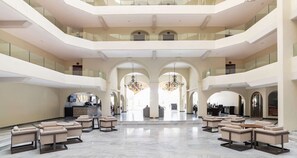 A spacious lobby with multiple seating areas, a reception desk, and a chandelier. - Awesome oceanfront resort with amazing Arch views in fabulous Cabo San Lucas (Cabo San Lucas)