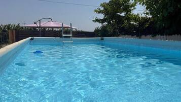 Seasonal outdoor pool, pool umbrellas, pool loungers