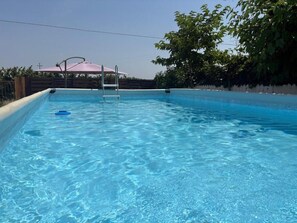Seasonal outdoor pool, pool umbrellas, pool loungers