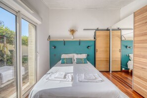 A modern bedroom with a bed, a window, and a wooden wardrobe. - Exceptional House with Private Pool Bordeaux (Bordeaux)