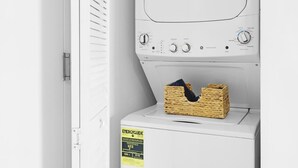 A front-loading washing machine with a control panel, a basket of laundry, and an ENERGYGUIDE label. - Intracoastal View Apt - Resort Amenities & Pool (Hallandale Beach)