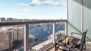 A balcony with a view of a marina and cityscape. - Beachwalk Studio Resort-Style Amenities (Hallandale Beach)