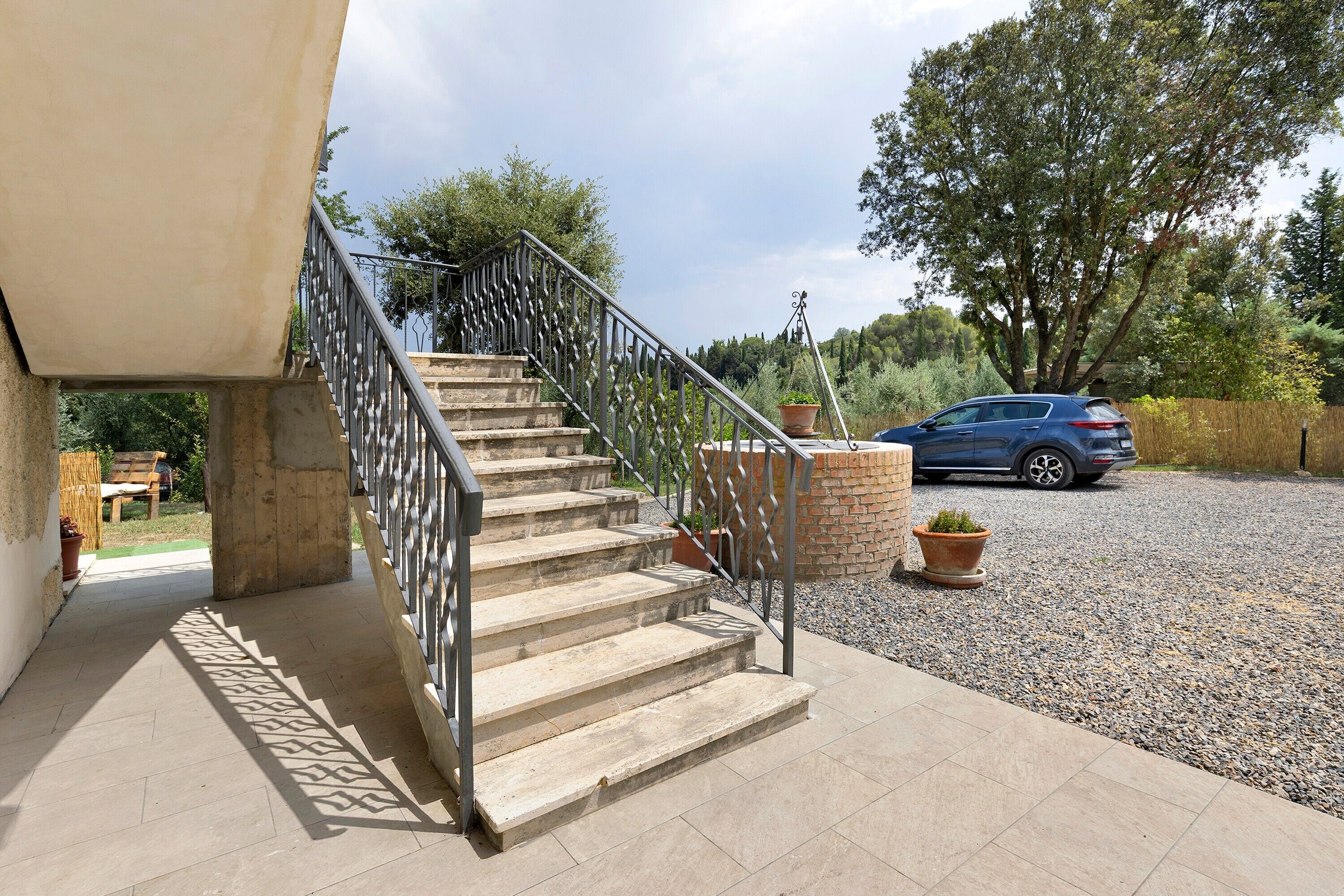 A staircase with metal railings leading to a building entrance.