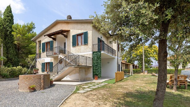 A two-story house with a balcony, a staircase, and a gravel driveway. - Apartment 'Terra' with Shared Pool, Garden, and Wi-Fi (Volterra)
