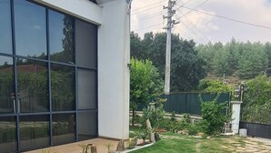 A modern building with large windows and a well-maintained lawn. - Serene 3-bedroom Villa Rental in Köyceğiz, Turkey (Koycegiz)