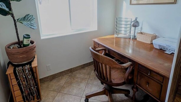 A room with a desk, chair, potted plant, and a window. - Spacious 2BR Getaway w/Hot Tub (Cochise County)
