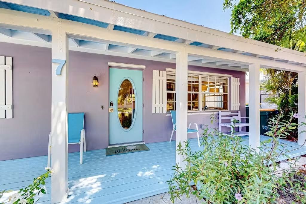 A house with a porch, a door with a window, and a number '7' on the wall.
