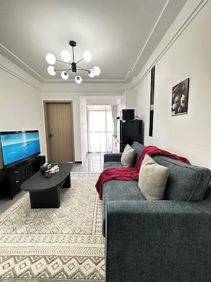 A modern living room with a flat-screen TV, a sofa, a coffee table, and a patterned rug. - Cozy Modern Mini 2BR, Close to Yaya Centre & Top Cafes.
Gym,kids play pen, (Nairobi)