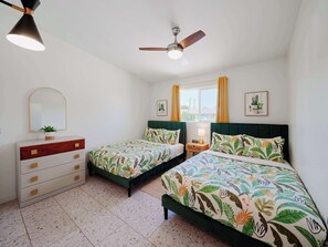 A bedroom with two single beds, a dresser, a ceiling fan, a window with curtains, and a wall-mounted mirror. - Desert Dream - Pool Heat Avail. - Mins to Old Town (Scottsdale)