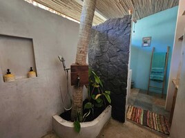 Deluxe Bungalow, Garden View | Bathroom | Shower, towels, soap, shampoo