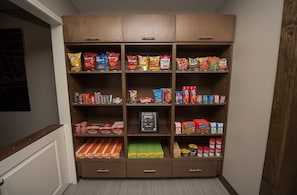 A pantry with various snacks and food items.