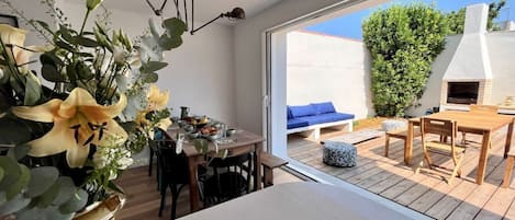 A modern kitchen with a dining area, a large window, and a view of the outdoors.
