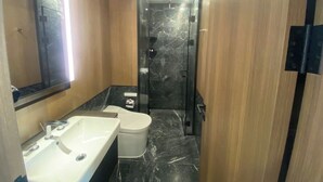 A bathroom with a sink, toilet, and shower. - Ho Chi Minh Living Hub Booking Network  (Ho Chi Minh City)