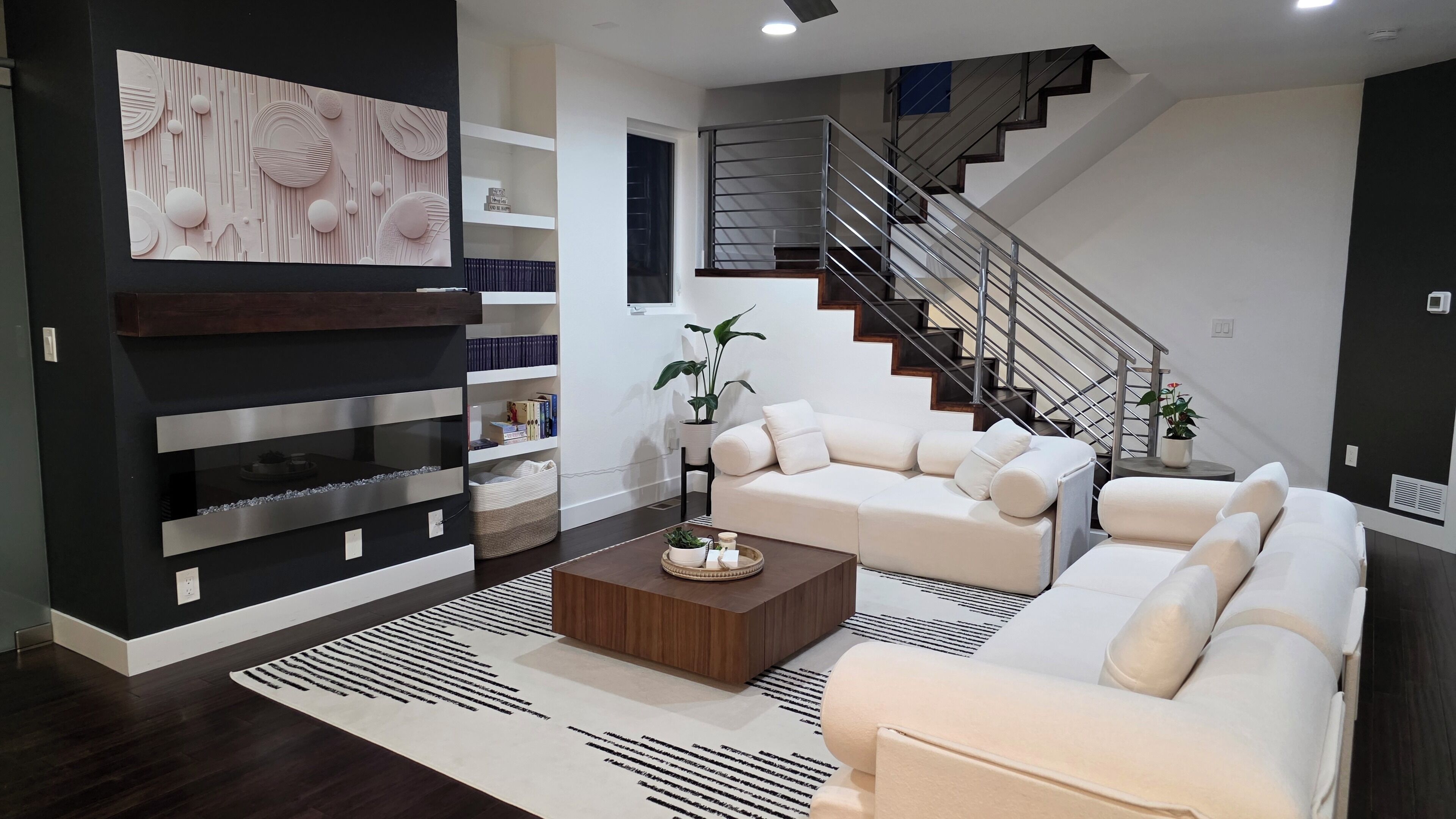 Uma sala de estar moderna com sofá, mesa de centro e arte decorativa na parede.