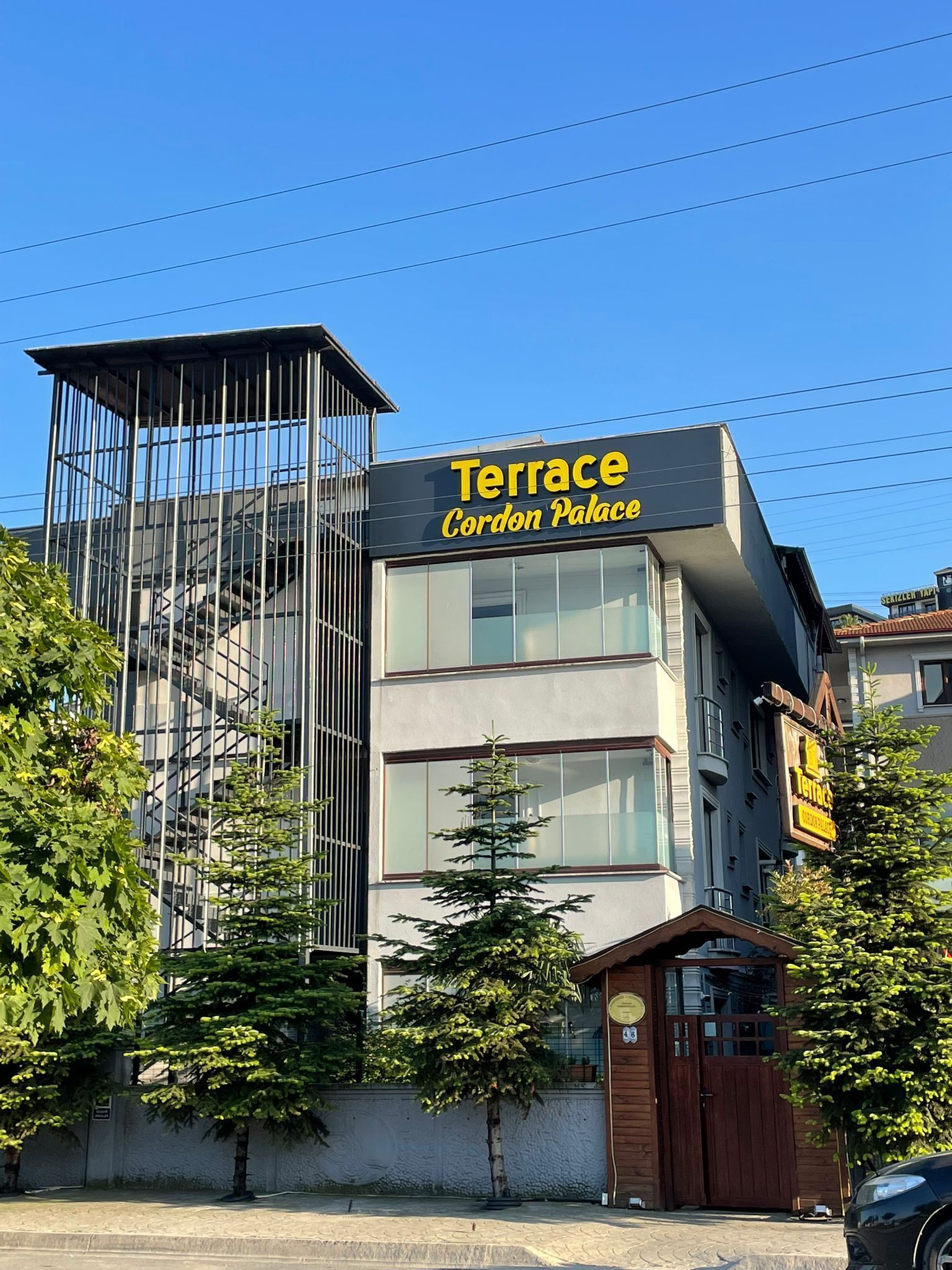 A building with a sign reading 'Terrace Cordon Palace' and a visible entrance.