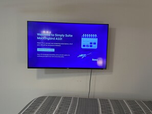 A television screen displaying a welcome message for Simply Suite Mockingbird A10, with options to select a checkout date and a note about terms and privacy policy. - Charming studio with AC in the heart of Little Rock (Little Rock)