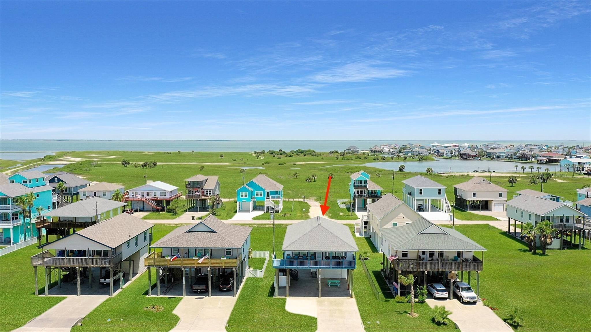 A coastal residential area with houses featuring balconies and waterfront views.