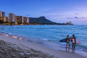 A beach with people, a mountain in the background, and buildings along the shore. - Ilikai Hotel & Luxury Suites | 2 Marina View Condos Sleeps 10 | Car Incl. w/ 6+Nights | ML-4247 by KBM (Honolulu)