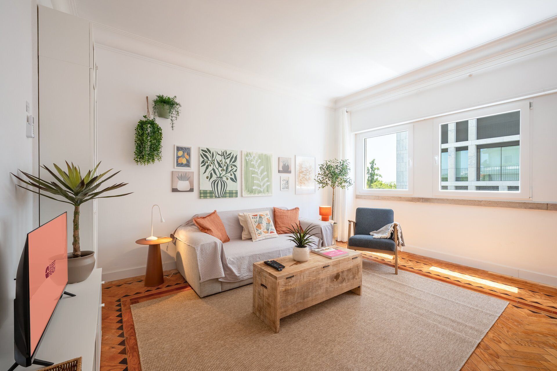 A modern living room with a sofa, coffee table, and a large window.