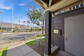 A building with a grey door, a small sign, and a clear sky.