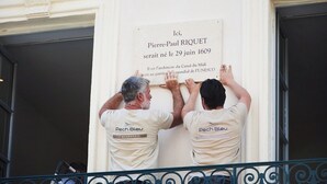 Two individuals installing a commemorative plaque on a building facade. - Cozy 1BR with A/C across les Halles (Tourcoing)
