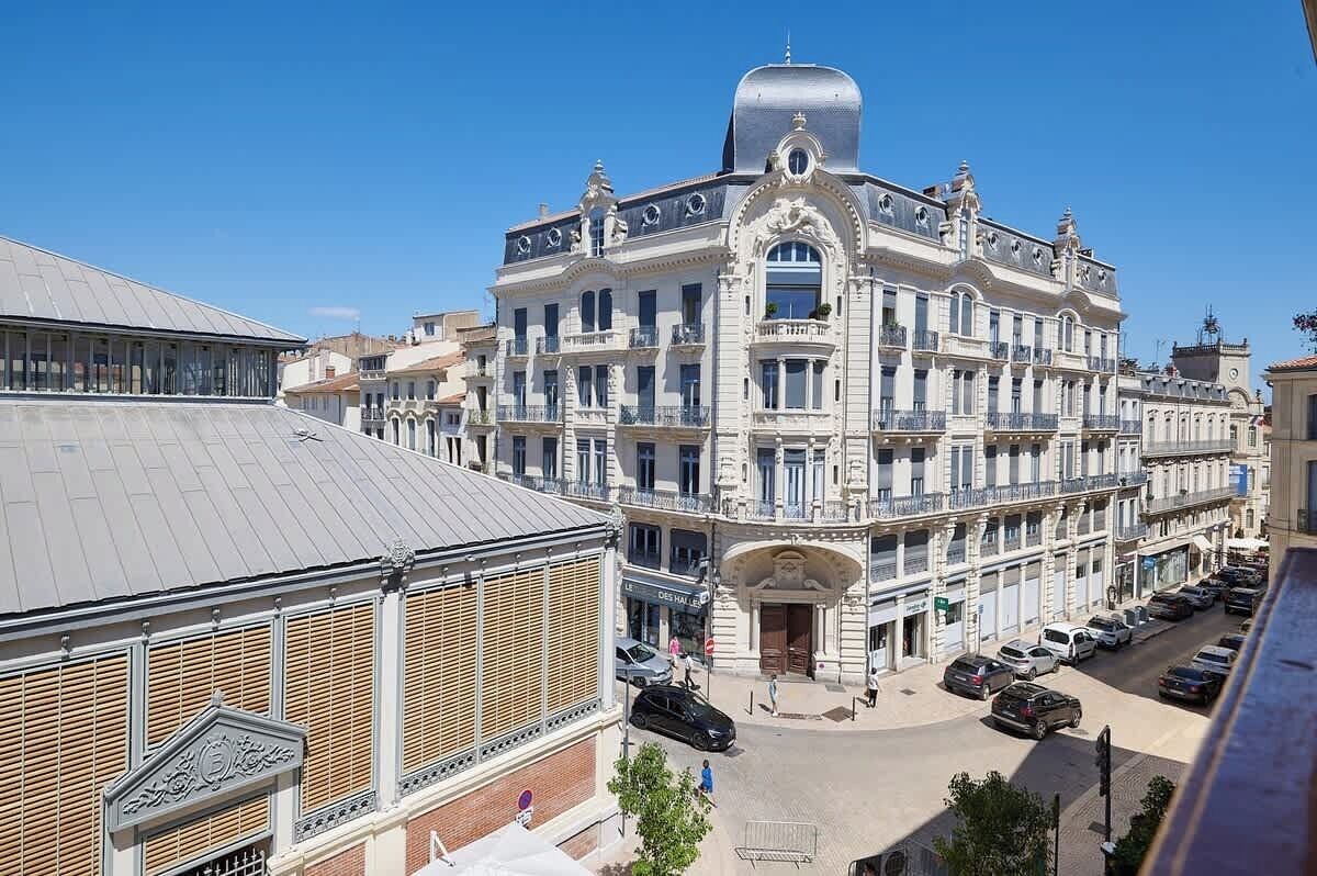 A historic building with a central dome and multiple balconies.