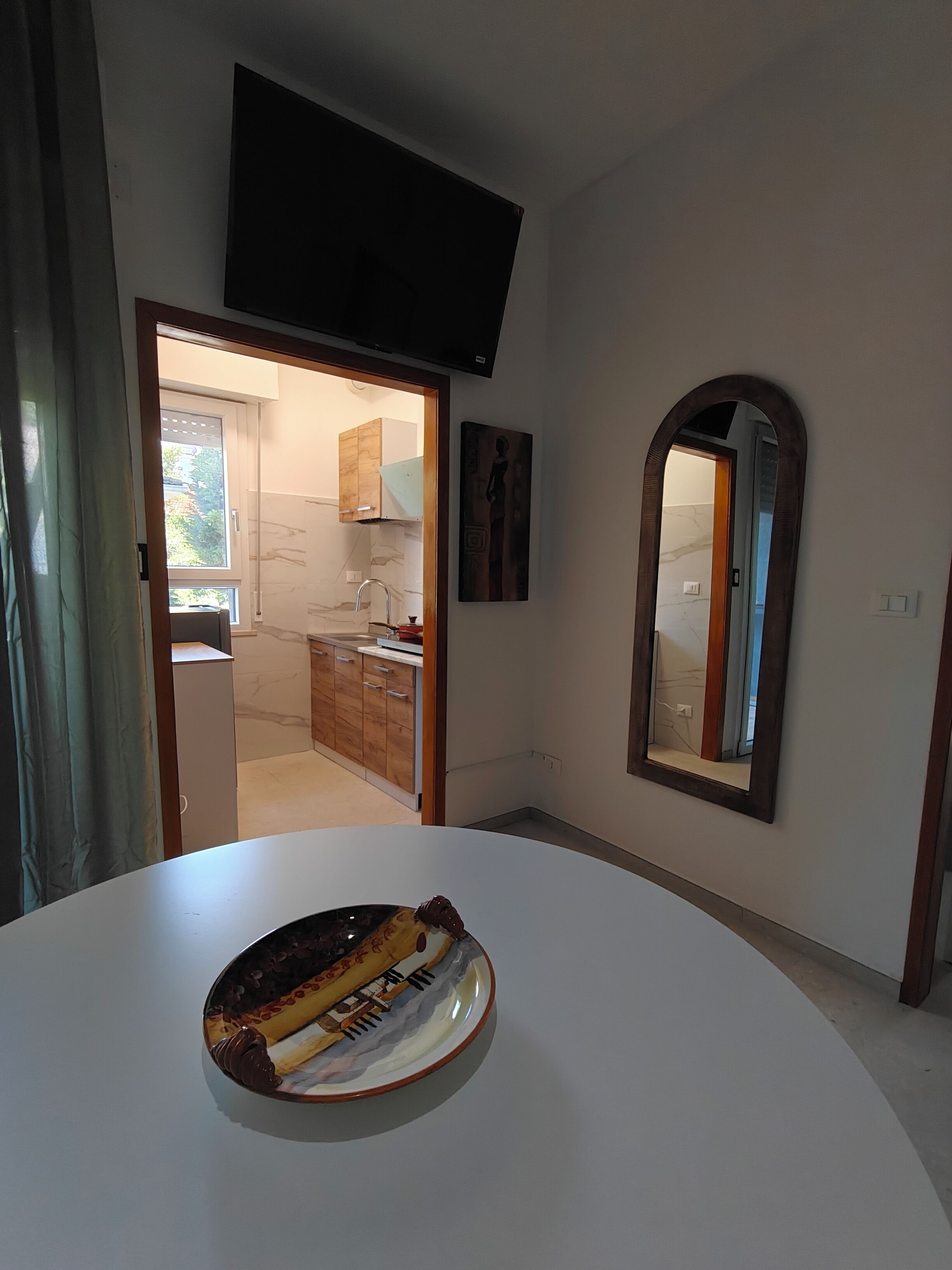 A modern kitchen with a built-in oven, a microwave, and a sink.