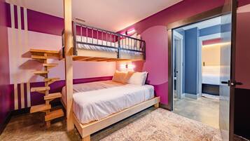 A bunk bed with a wooden ladder, a white mattress, and a pink wall.