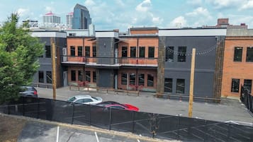 A multi-story building with a parking lot in front.