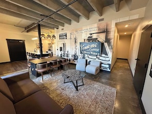 Un interior moderno con una zona de bar, asientos y un gran letrero que anuncia Vendome & Copper Brass Works.