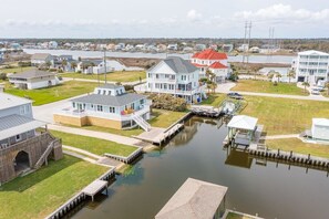 A residential area with houses, a dock, and a water body. - Canalfront dock, boat ramp and hot tub (North Topsail Beach)