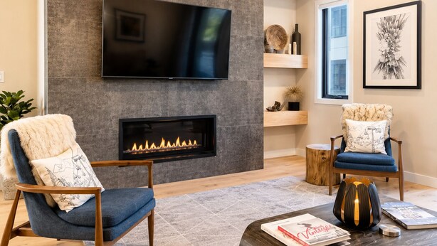 A modern living room with a fireplace, a flat-screen TV, and a cozy seating area. - Tamarack Resort Village Ski In Ski Out Condo - Year Round Resort (Donnelly)